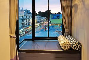 a window seat in a room with a view of a city at Srisawara Casa Hotel in Krabi town