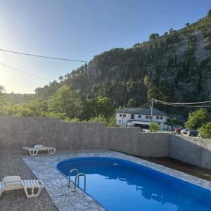 a swimming pool with a view of a mountain at Vila Nomada in Blagaj