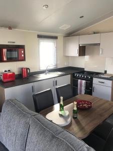 a kitchen with a table with two bottles on it at Crimdon dene holiday park in Hartlepool