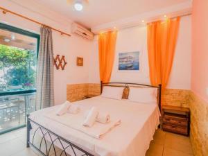 a bedroom with a bed with two pillows on it at Apartment in Mpenitses with Sea Views in Benitses +32 photos