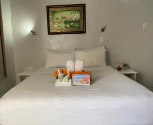 a bedroom with a bed with a box on it at Lalaguna Villas Luxury Dive Resort and Spa in Puerto Galera