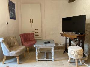 a living room with a tv and a table and chairs at TheRoom in Šibenik