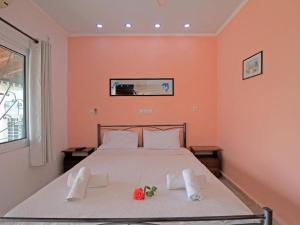 a bedroom with a bed with towels on it at Alluring apartment in Mpenitses with shared pool in Benitses