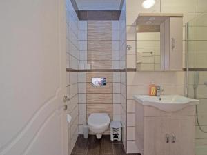 a bathroom with a toilet and a sink at Alluring apartment in Mpenitses with shared pool in Benitses +36 photos