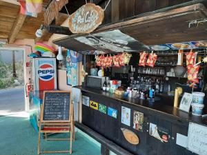a bar with a sign and a chair in front of it at Apartment in Mpenitses with Sea Views & Pool in Benitses