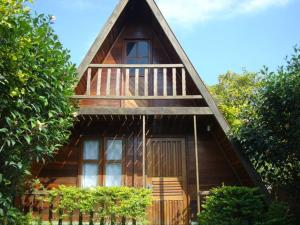 a wooden cabin with a porch and a balcony at Chalès em Ilhabela Litoral Norte in Ilhabela +6 photos