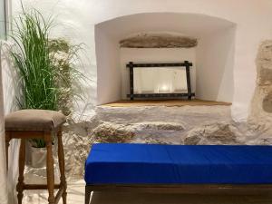 a room with a blue mattress and a fireplace at TheRoom in Šibenik