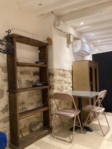 a room with a table and chairs and a refrigerator at TheRoom in Šibenik