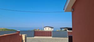 a view of a building with a fence and a house at Hollidays Dreams in Póvoa de Varzim