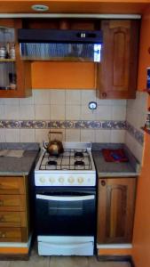 a kitchen with a stove with a tea kettle on it at Residencia "Libertad" in San Andrés
