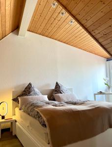 a bedroom with a large bed with a wooden ceiling at Anton-Ulrich Apartment in Meiningen