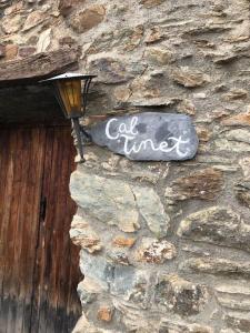 um sinal no lado de uma parede de pedra em Charming Stone House in the Pre-Pyrennes em Ribes de Freser