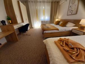 Postel nebo postele na pokoji v ubytování Studio Apartmani “Jarnečić”