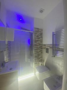 a bathroom with a shower and a toilet and a sink at Mamuccia Rooms Posto Auto in Naples +44 photos