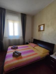 a bedroom with a large bed with a colorful blanket at Da Barbara & Simone in Collemezzano