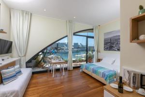 a hotel room with a bed and a large window at Locanda da Toto in Genova