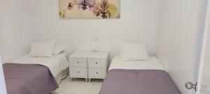 Posteľ alebo postele v izbe v ubytovaní Apartamento junto a la playa. Corralejo + 30 fotografií