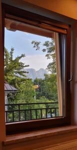 a window with a view of a mountain view at Apartament Orkisz in Zakopane