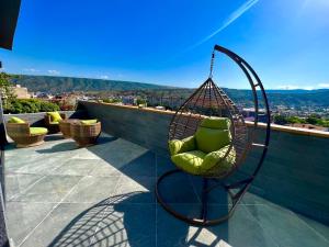 a swing chair sitting on top of a roof at Hotel Address 9D in Tbilisi City
