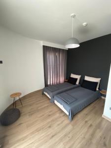 Un dormitorio con una cama y una mesa. en MERDZ Spa & Fitness Sky Apartment en Skopje