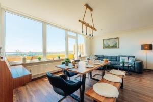 a living room with a table and a couch at Penthouse Harz-Traum 372 in Hohegeiß