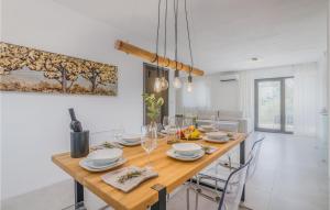 a dining room with a wooden table and chairs at Awesome Home In Klimno With Kitchen in Klimno