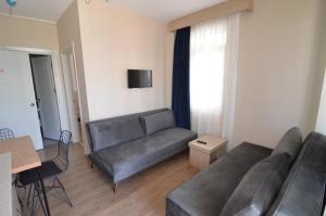 a living room with a couch and a table at Arda Apart Hotel in Kemer