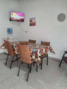 a table and chairs in a room with a television at Casa Quinta en Luján - Olivera in Olivera