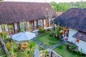 an aerial view of a house with an umbrella at Kamasanti Hostel in Nusa Penida