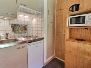 una piccola cucina con lavandino e forno a microonde di Studio Méribel, 1 pièce, 2 personnes - FR-1-182-54 a Méribel