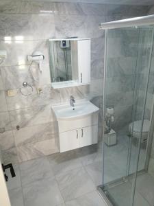 a bathroom with a sink and a glass shower at Bo homes suıt apart in Demre