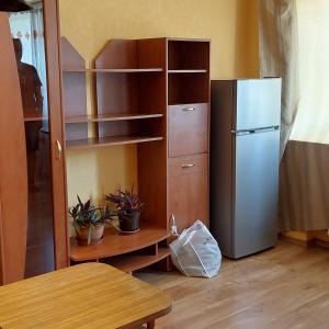 a kitchen with a refrigerator and a table and a table at 2 room apartment 350 m from sea in Liepāja