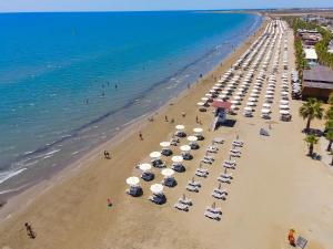 an overhead view of a beach with umbrellas and the ocean at The Ciao Stelio Deluxe Boutique Hotel - Adults Only in Larnaka