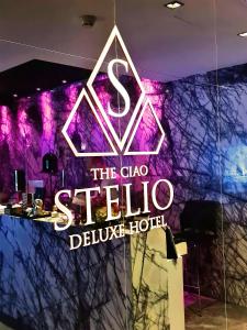 a neon sign for the club stella deluxe hotel at The Ciao Stelio Deluxe Hotel (Adults Only) in Larnaca