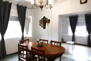 a dining room with a wooden table and chairs at Casa L'Era 1967 in Pau