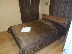 a hotel room with a bed with a napkin on it at Motel Sapnis in Jēkabpils