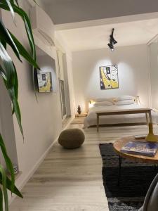 a bedroom with a bed and a table and a plant at Shi Zi Junior Suite in Iaşi