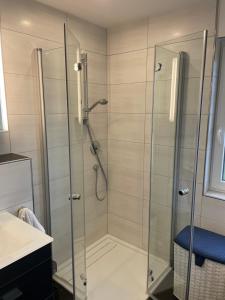 a bathroom with a shower with a glass door at Haus am Rösberg in Bornheim