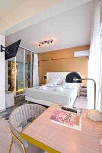 a bedroom with a bed and a table with a book at John's Hotel in Chalkida