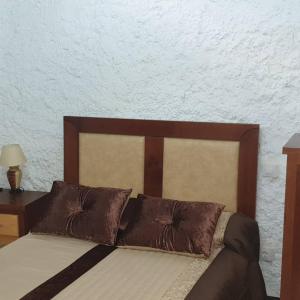 a bed with two brown pillows on top of it at Silo el capricho in Madridejos