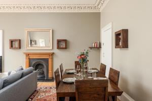 a living room with a table and a couch at 2 Bed Old Town Apartment - Next To Castle in Edinburgh