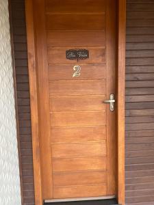 a wooden door with the number two on it at Águia Dourada Hospedagem Casa 02 in Bom Jardim da Serra