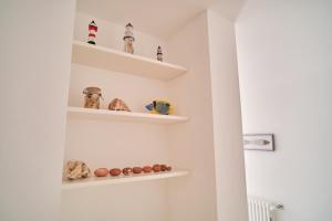 a room with shelves on the wall at Casa Margherita - typical salento house in Castrignano del Capo