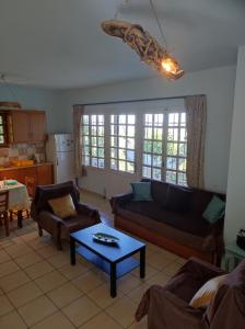 a living room with a couch and a table at Anatolika Stamatis Paradise in Dhémbla