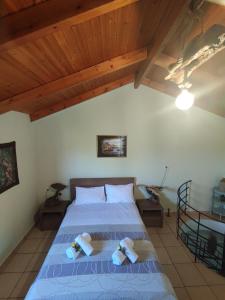 a bedroom with a bed with blue sheets and wooden ceilings at Anatolika Stamatis Paradise in Dhémbla