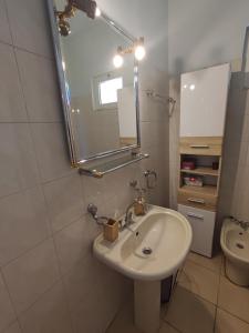 a bathroom with a sink and a mirror and a toilet at Anatolika Stamatis Paradise in Dhémbla +144 photos
