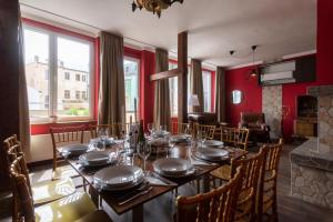 a dining room with a table with plates and glasses at Golden Tree Loft in the Heart of Prague in Prague