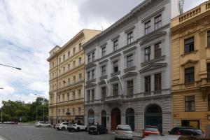 a large building with cars parked in front of it at Golden Tree Loft in the Heart of Prague in Prague