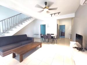 a living room with a couch and a ceiling fan at ₘₐcₒ ₕₒₘₑ Premium Suite 3R2B CorNer @Mount Austin 【TMN DAYA】 in Johor Bahru