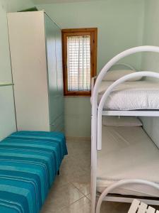 a room with two bunk beds and a window at Gorgo House in Lascari